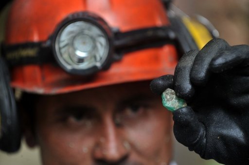 Colombian miner Enrique Aldana looks at an emerald outside the mine "La Espanola" (The Spaniard), near Muzo, department of Boyaca, on January 24, 2013. Colombia is the world's largest producer of emeralds. AFP/Guillermo Legaria.