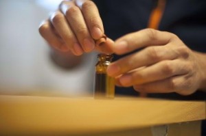 A Colombian drug dealer opens a bottle with a liquid solution containing cocaine, in Bogota, on September 20, 2013A Colombian drug dealer opens a bottle with a liquid solution containing cocaine, in Bogota.