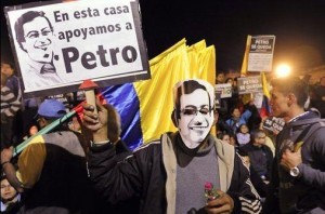 A supporter of Bogota's Mayor Gustavo Petro holds a sign reading in Spanish "In this home we support Petro" in front of city hall in Bogota, Colombia, Monday, Jan. 13, 2014. Colombia's Inspector General Alejandro Ordonez ratified on Monday the impeachment of Petro for the mismanagement of the city's garbage collection system. Carlos Julio Martinez / AP Photo 