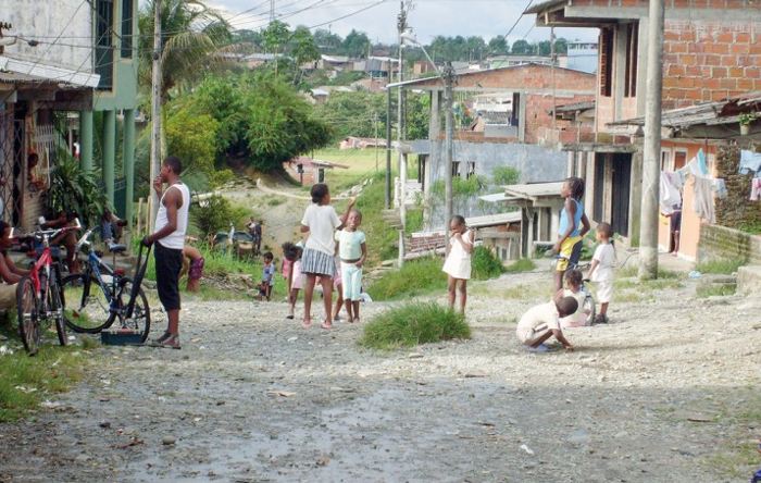 Children play in a street in beleaguered Buenaventura. Expanding trade in Colombia’s largest port has displaced thousands of poor Colombians already pressed hard by poverty and violence.